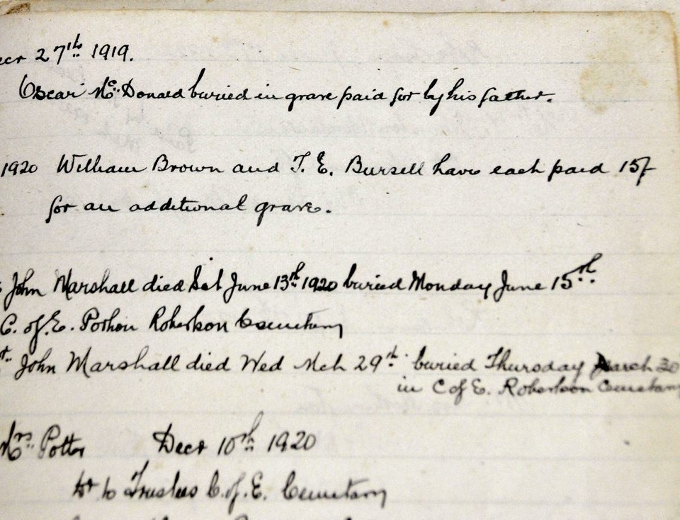 Burial record of Oscar McDonald recorded in an old book in the General Store at Robertson.