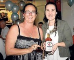 LADY LUCK: Jennie Wilcox presents Debbie White with her lucky door prizes. Debbie was very lucky on the night, also winning one of the raffle prizes, which she decided to donate back.