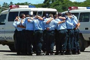 AFP officers farewell their mate Adam Dunning after loading his coffin into a RAAF jet at Honiara Domestic Airport. Photo: Andy Zakeli