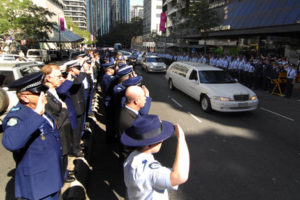 Queensland Police line the streets in a guard of honor for Constable Brett Andrew Irwin while his casket is escorted from the St Stephens Cathedral in Brisbane. Picture: AAP/Tony Phillips