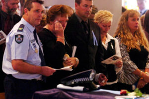 Ferny Grove Police station officer in charge Andy Graham (left) with Constable Brett Andrew Irwin's mother Chris Irwin (centre), brother Mick Irwin and family during the officer's funeral at the St Stephens Cathedral. Picture: AAP/Tony Phillips