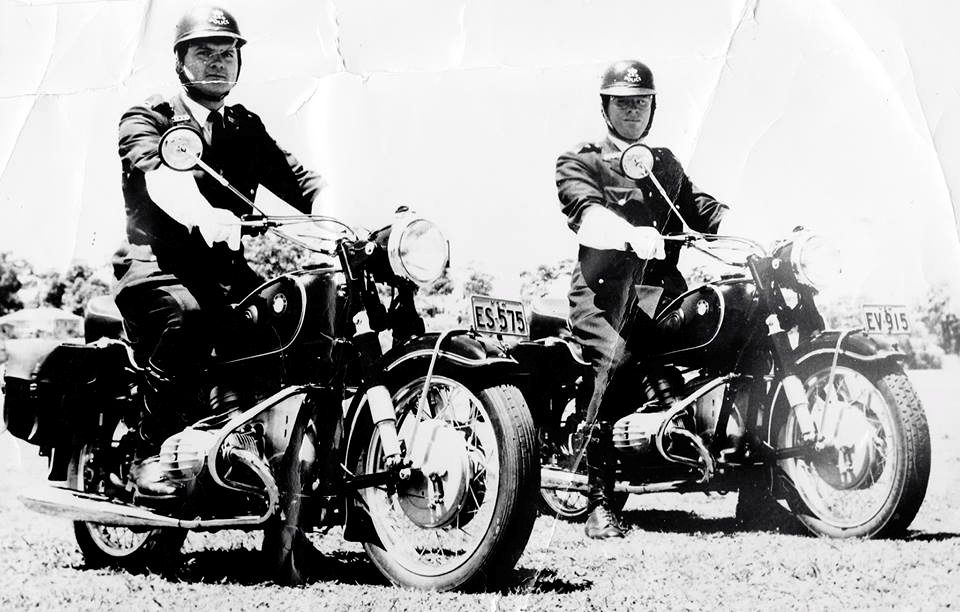 John Burton Gibbs (right) riding Police cycle EV-915, with Noel Patmore, riding Police cycle ES-575, at Figtree Oval in 1961...  the photo is captioned "Escorting Mr Maloney" to Wollongong.