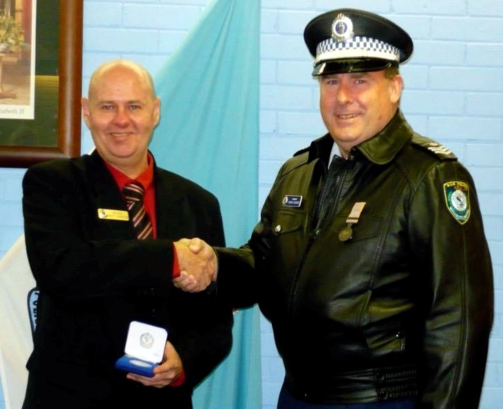Brett being presented his NSWP Medallion - 10 years, by Sgt 2/c ( Ret. ) Craig Bishop - Head of Academy Security.