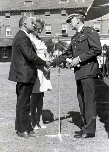 Donald and June Flavel accepting Certificate at the Robert John FLAVEL<br /> Donald and June Flavel accepting Roberts Graduation Certificate, his Police Cap, Epaulettes and Badge at the Redfern Police Academy - the day Roberts Cadet Class Passed Out ( Attested )<br /> Unknown Police Officer.