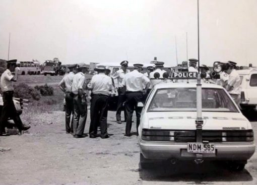 This picture is of John Hardaker and other officers. Location - Broken Hill, Mitch Hardaker, Johns son, was told that this was taken whilst Mad Max 3 was being filmed out there. You can see the old bus on the left of the picture.