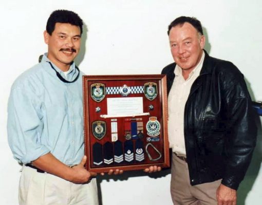 Sgt Manni VERSOZA ( Wollongong Police Rescue Squad OIC ) presenting a Retirement gift to Retired SenSgt John BYERS ( outgoing Wollongong Police Rescue Squad OIC )