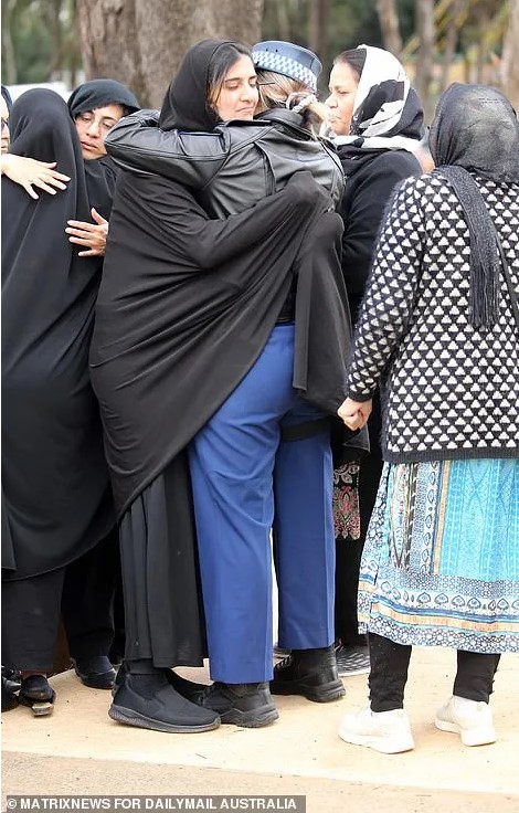Tanzeel Iftikhar BASHIR. Constable Tanzeel Bashir’s mother Rani (left and right) was comforted by her son’s grief-stricken colleagues at the funeral and burial.