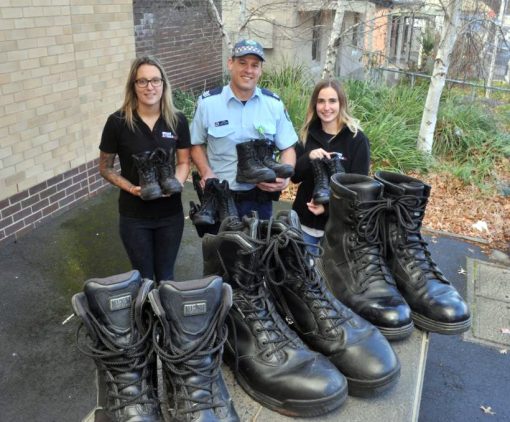 Gregory Ross PAYNE, Gregory PAYNE, Greg PAYNE. WALKING BOOTS: Sergeant Greg Payne hands over spare boots to help city's homeless to Mission Australia case workers Jess Wright (left) and Kelsey Lew. Photo: JUDE KEOGH 0816jkboots1